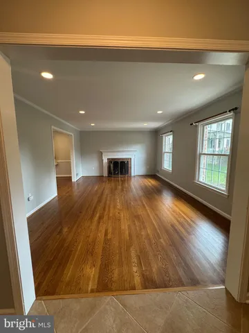 a big room with wooden floor and windows