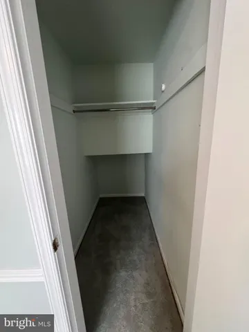 a view of staircase with white walls and a window