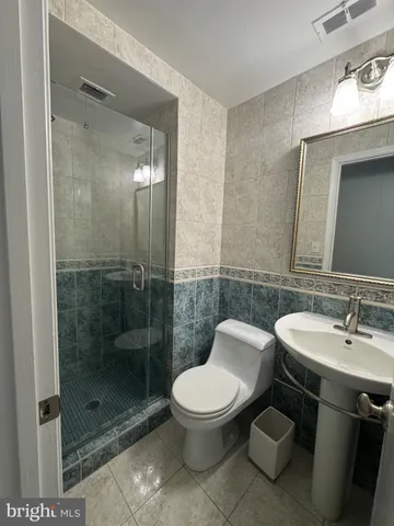 a bathroom with a toilet sink and shower