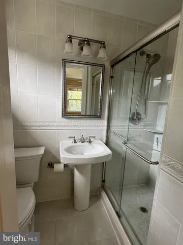 a bathroom with a toilet sink and shower