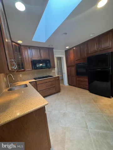 a kitchen with stainless steel appliances a sink and a stove top oven