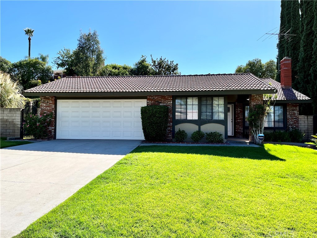 6835 Wilding Place Riverside, CA 92506 - Photo 1 of 1 a front view of a house with garden