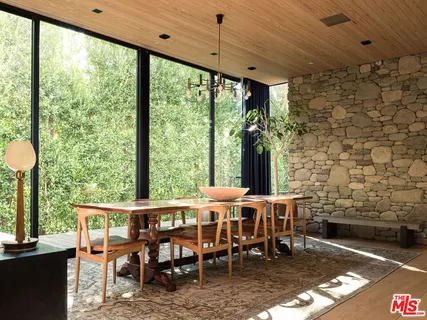 a living room with patio furniture and a flat screen tv