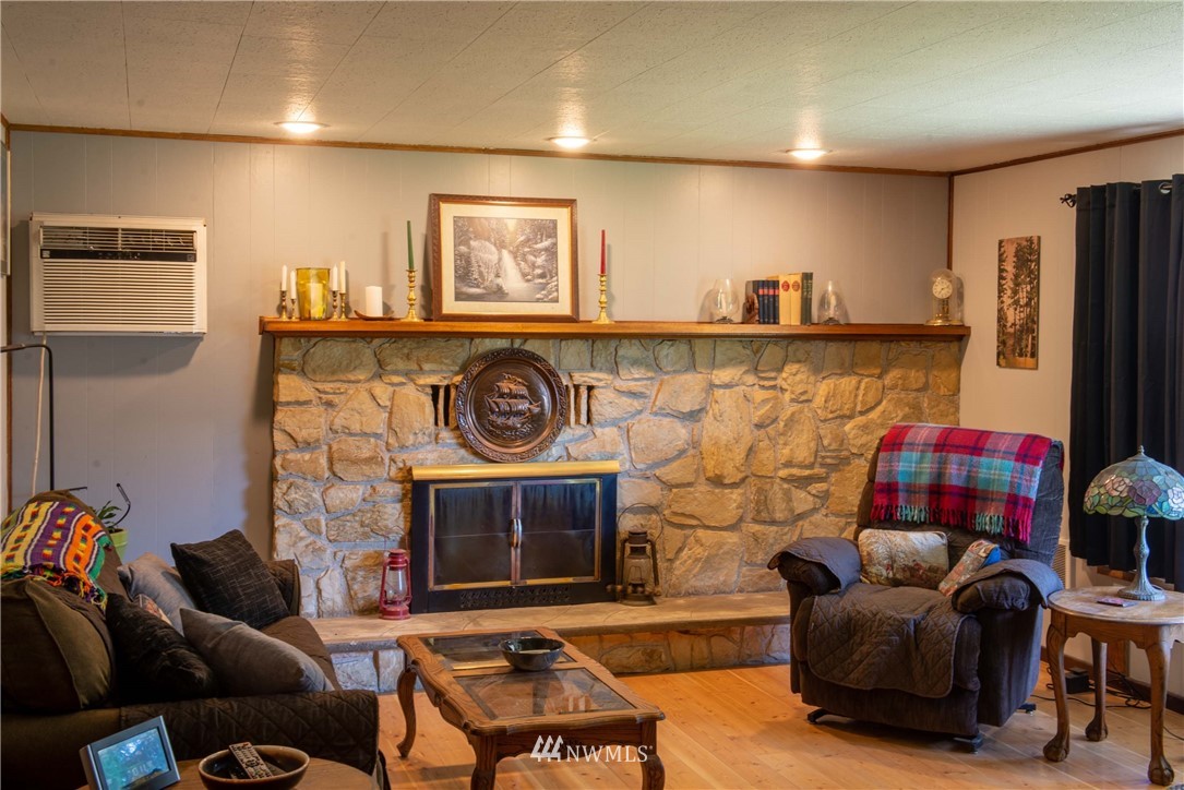 78 Mundy Road Twisp, WA 98856 - Photo 13 of 40 a living room with a couch and a fireplace