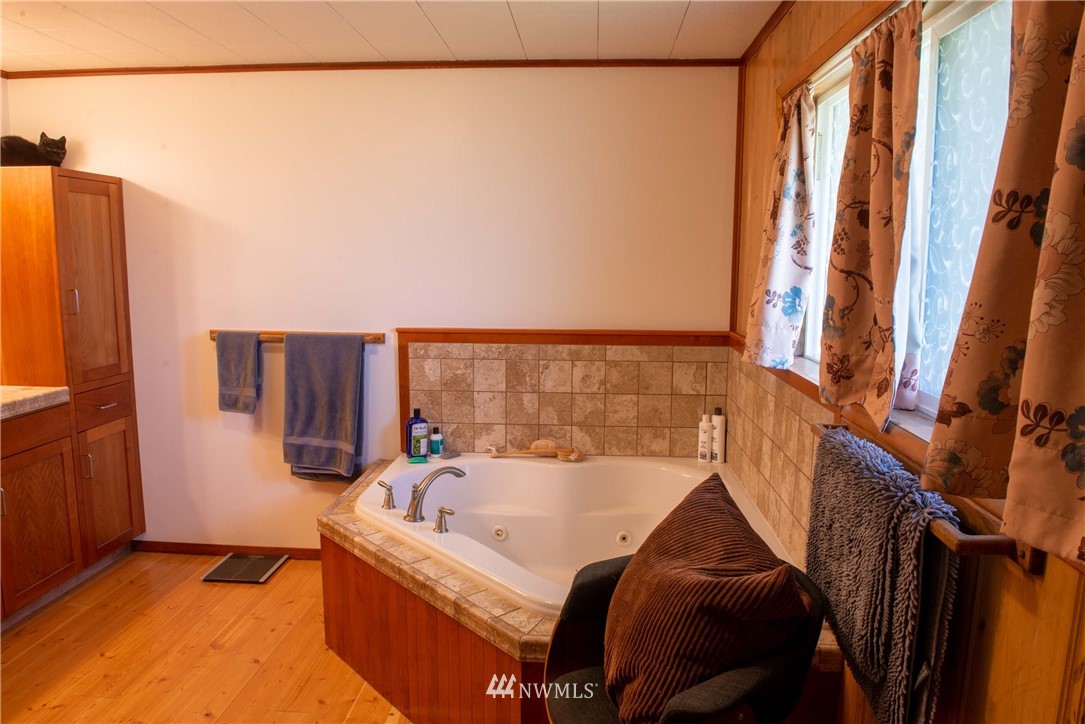 78 Mundy Road Twisp, WA 98856 - Photo 17 of 40 a bed sitting in a bedroom next to a window