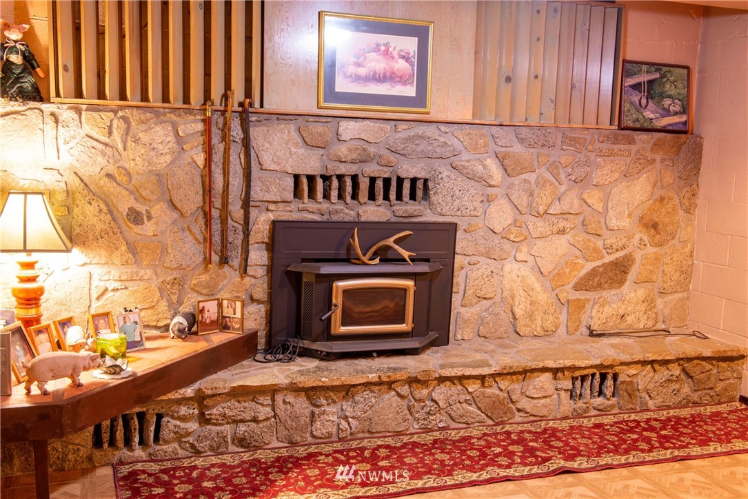 78 Mundy Road Twisp, WA 98856 - Photo 25 of 40 a view of a fireplace with wooden floor