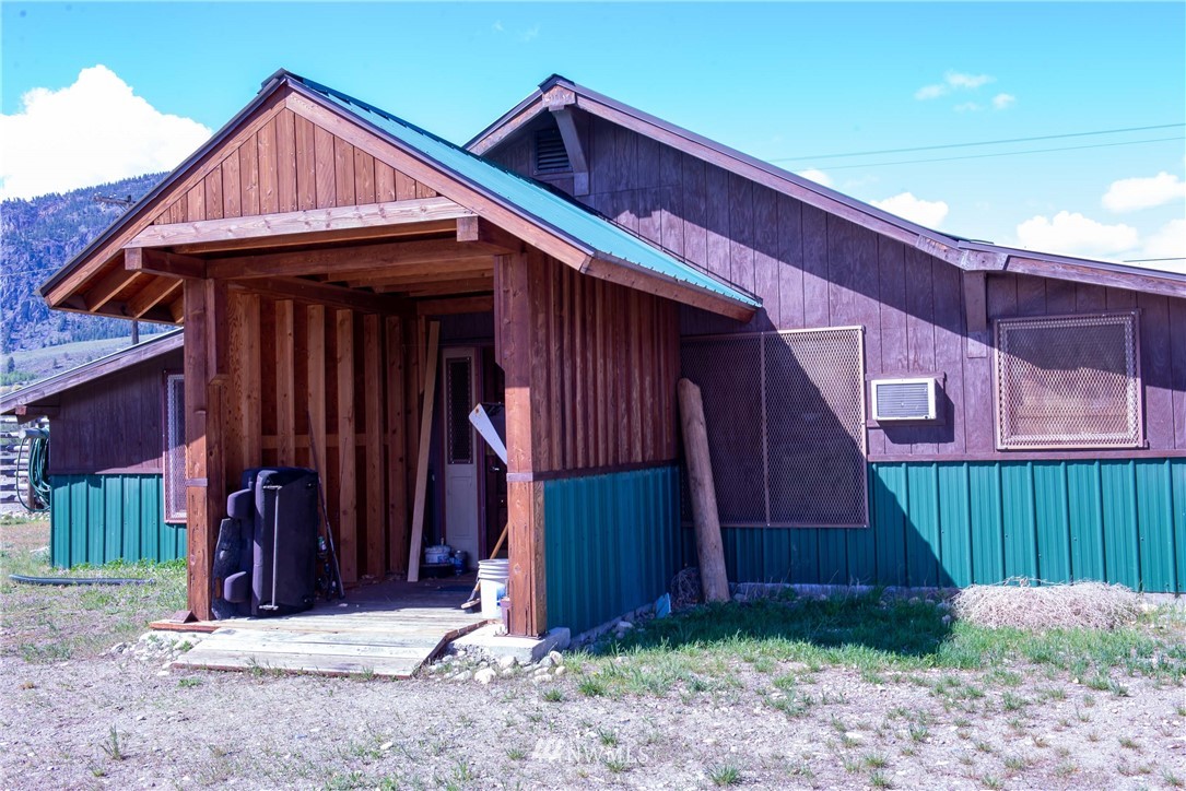 78 Mundy Road Twisp, WA 98856 - Photo 29 of 40 a front view of a house with garage