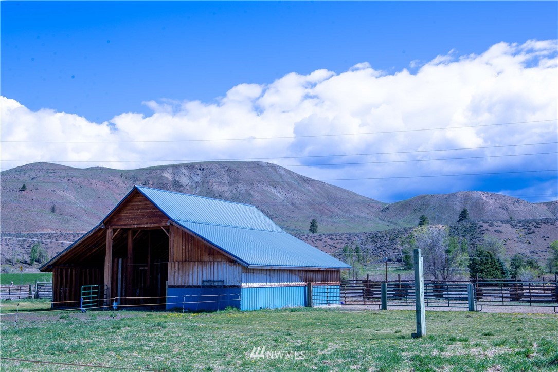 78 Mundy Road Twisp, WA 98856 - Photo 33 of 40 a view of barn with wooden fence and a yard