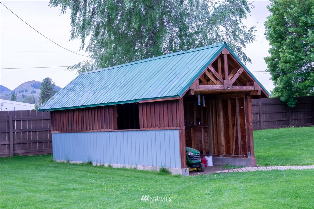 78 Mundy Road Twisp, WA 98856 - Photo 34 of 40 a backyard of a house with wooden fence and a toy car
