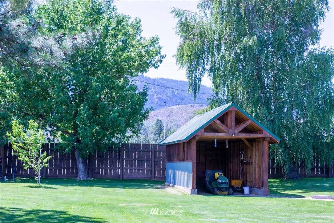 78 Mundy Road Twisp, WA 98856 - Photo 38 of 40 a view of a house with a small yard and a large tree