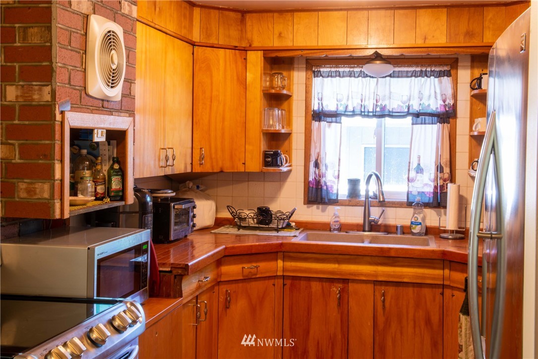 78 Mundy Road Twisp, WA 98856 - Photo 5 of 40 a kitchen with stainless steel appliances a sink and a window