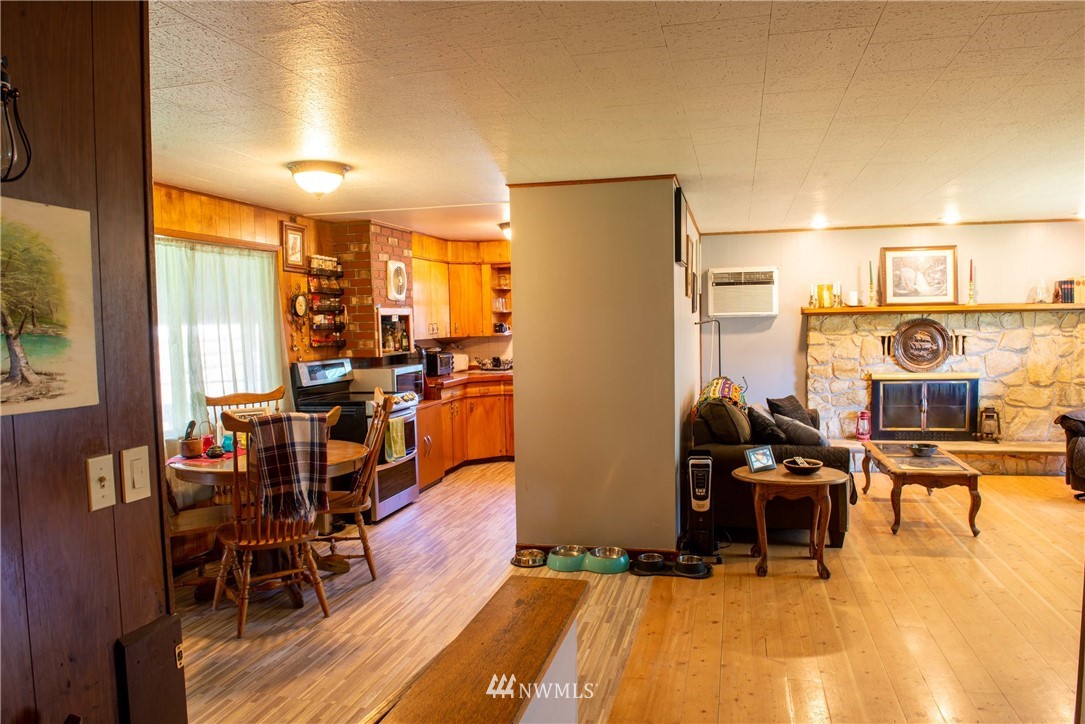78 Mundy Road Twisp, WA 98856 - Photo 6 of 40 a view of a dining room with furniture window and wooden floor