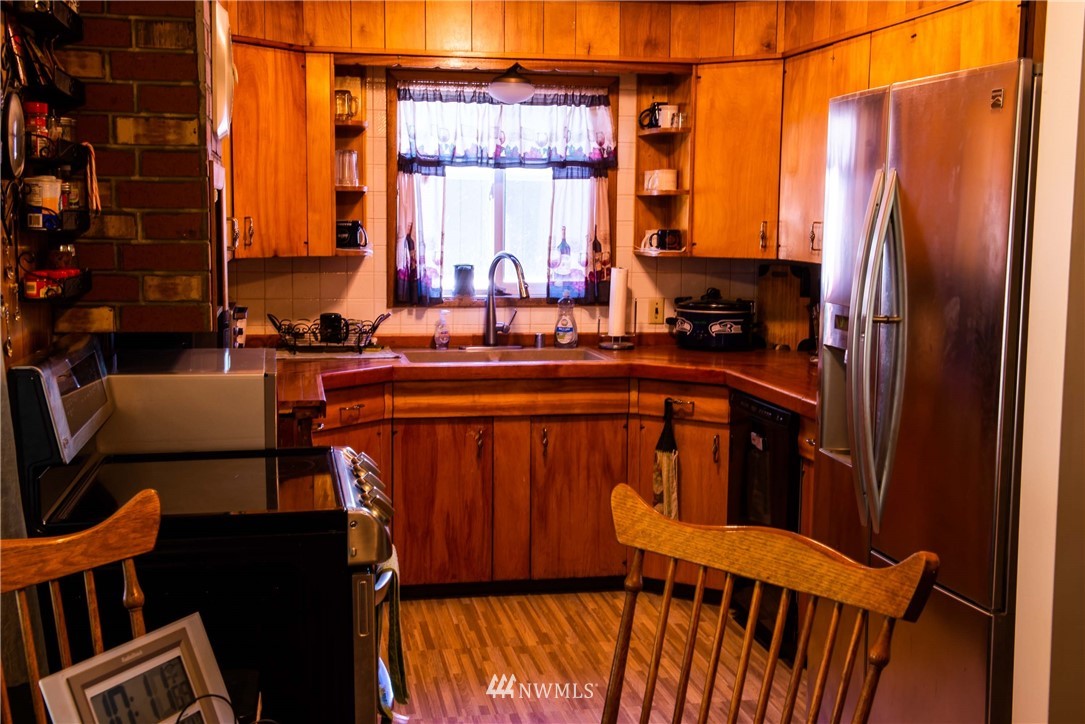78 Mundy Road Twisp, WA 98856 - Photo 7 of 40 a kitchen with stainless steel appliances a refrigerator a sink a stove and furniture