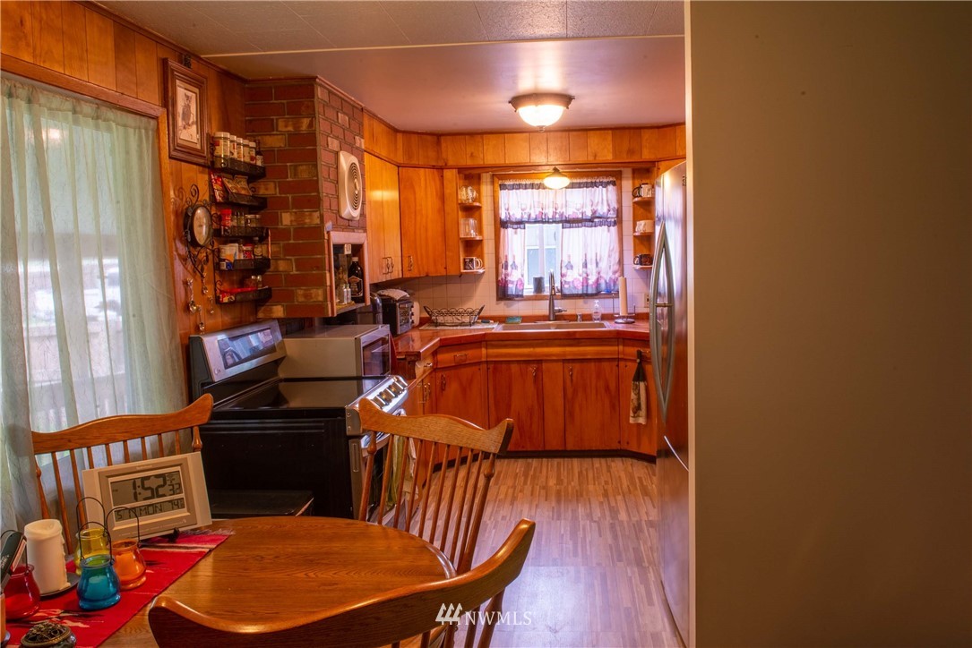 78 Mundy Road Twisp, WA 98856 - Photo 8 of 40 a view of a dining room with furniture window and wooden floor