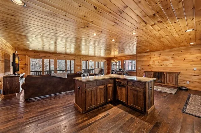 a living room with furniture a flat screen tv and a large window
