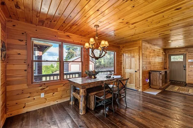 a bedroom with a bed next to a window with the outer view