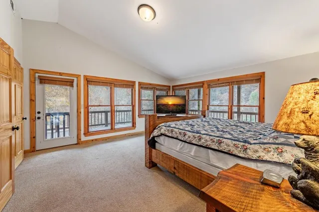 a view of a livingroom with furniture & a flat screen tv