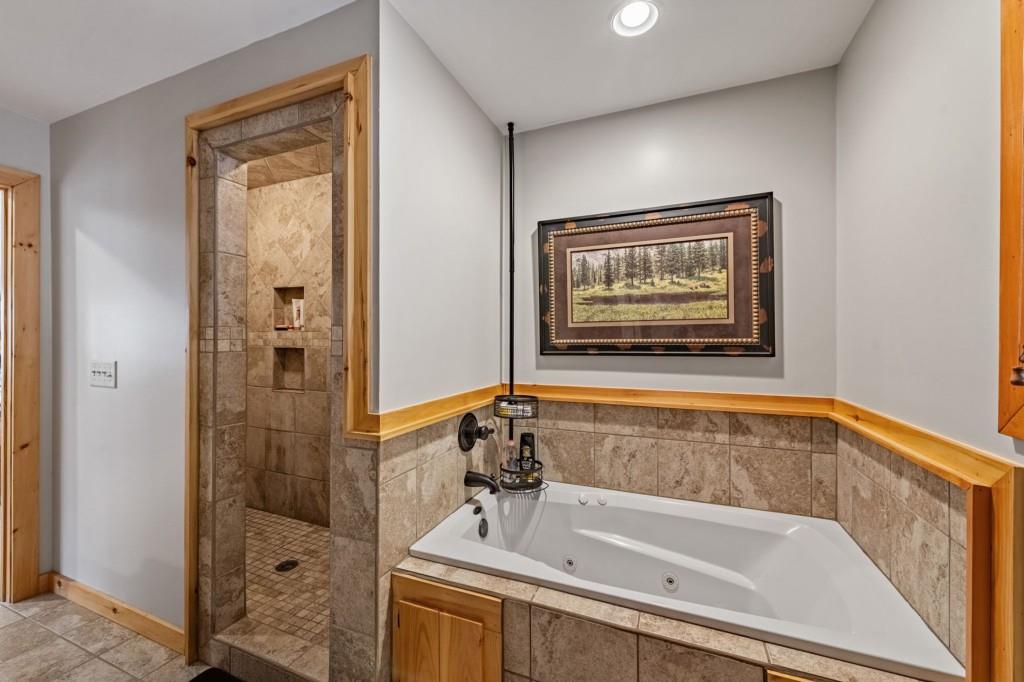 908 Cashes Valley Road Cherry Log, GA 30522 - Photo 41 of 90 a bathroom with a tub and shower