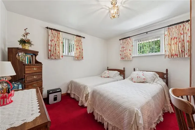 a bedroom with two beds and a chandelier
