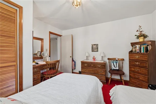 a bedroom with a bed and a dresser in it