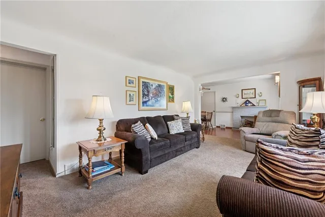 a living room with furniture a couch and dresser