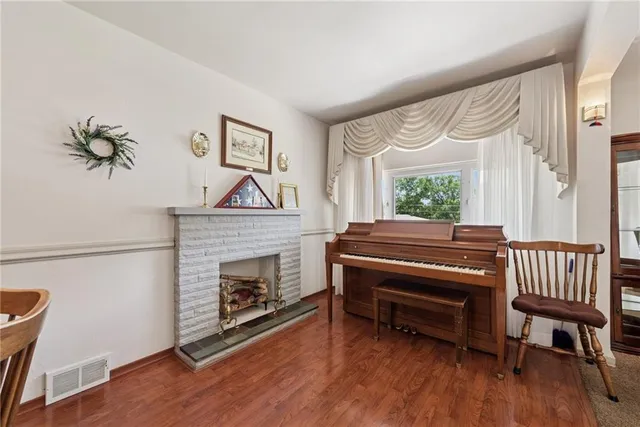 a living room with furniture a fireplace and a window