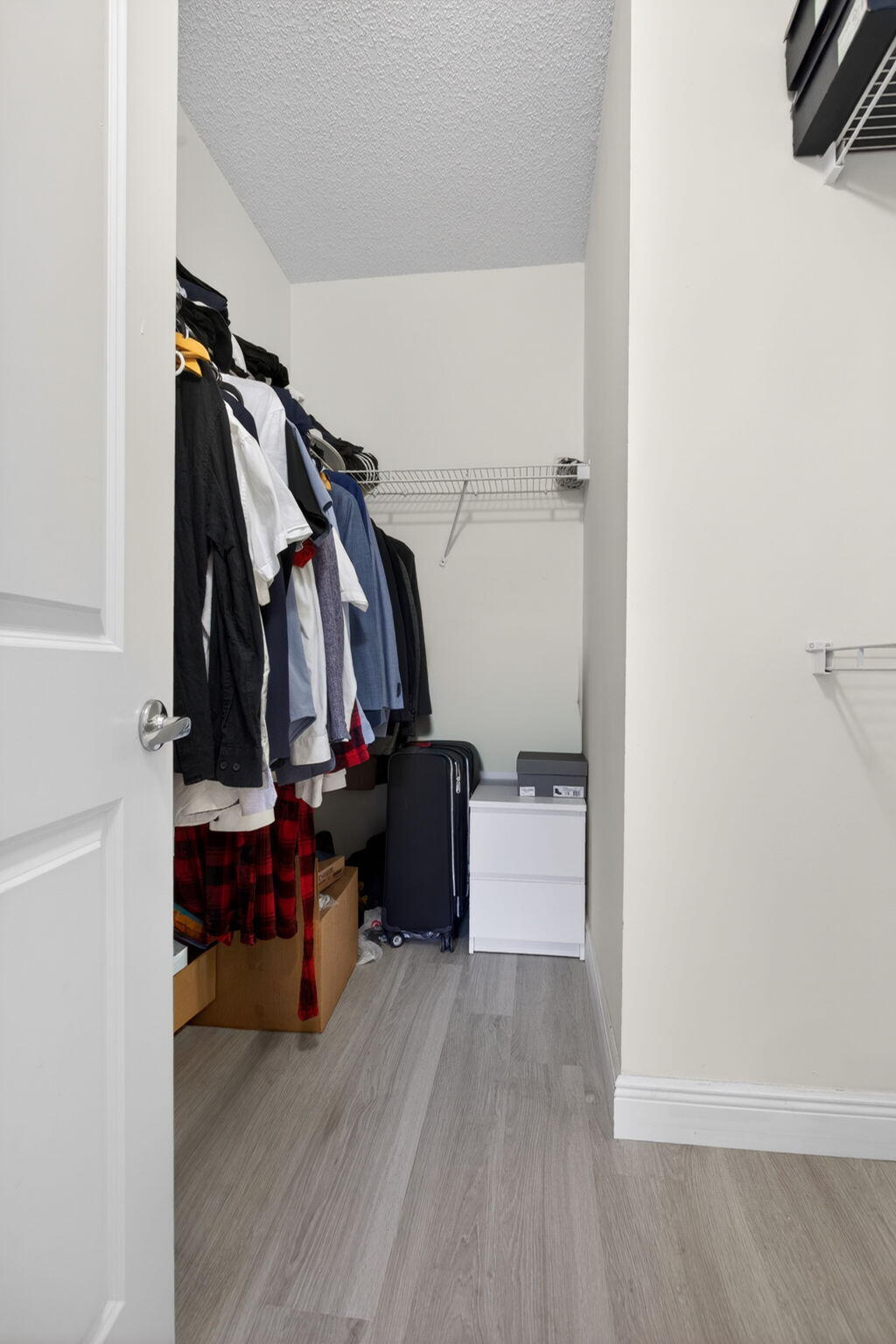 5880 West Sample Road, Unit 206 Coral Springs, FL 33067 - Photo 29 of 37 a view of walk in closet with clothes and shoes