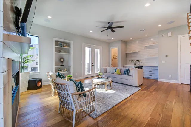 a view of an empty room with wooden floor and cabinet