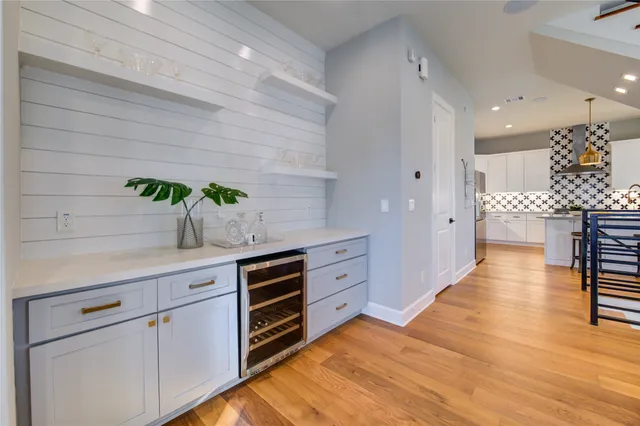 a bedroom with a bed wooden floor and a large window
