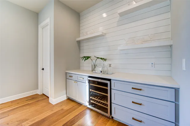 a bedroom with a bed and a wooden floor