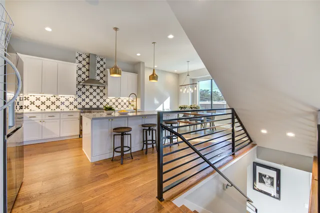 a kitchen with stainless steel appliances granite countertop a sink stove and cabinets