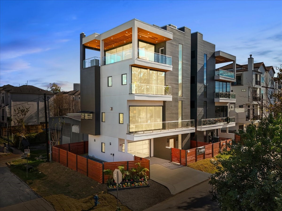 516 Reinerman Street Houston, TX 77007 - Photo 1 of 42 This photo showcases a modern, multi-story home with clean lines and large windows, offering ample natural light. It features multiple balconies and a sleek, contemporary design, situated in a well-kept neighborhood.
