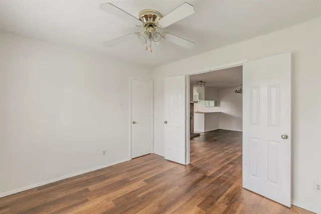 a view of a room with a sink and a chandelier fan