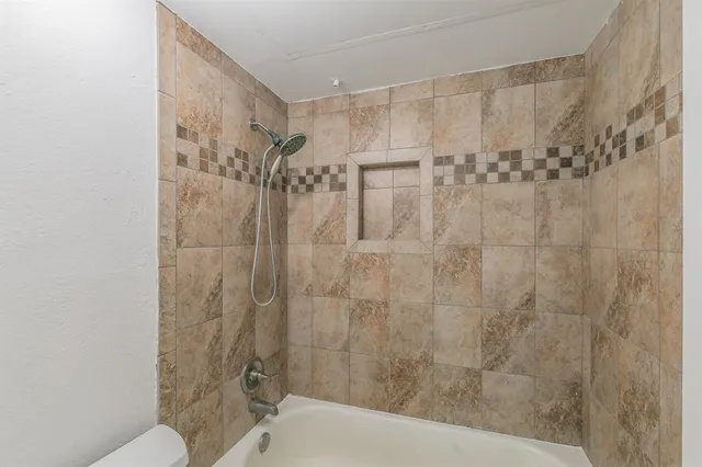 a bathroom with a shower and a toilet