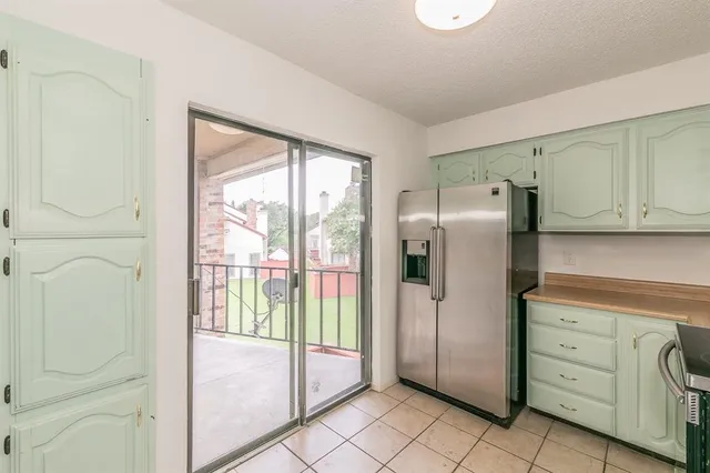 a kitchen with stainless steel appliances a refrigerator and cabinets