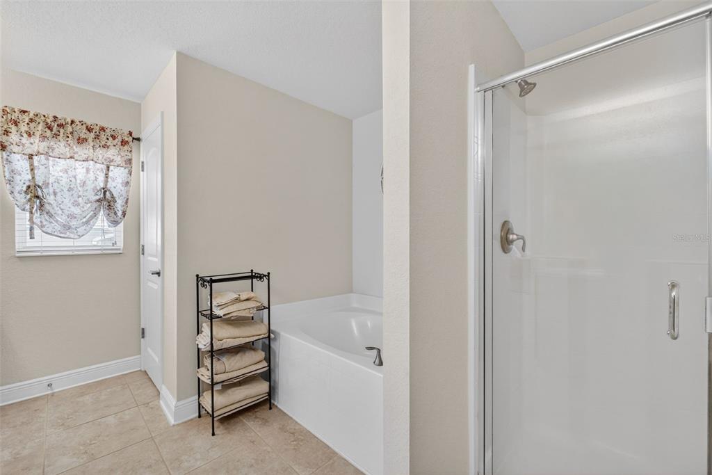 2429 Twin Lake View Road Winter Haven, FL 33881 - Photo 32 of 37 a bathroom with a bathtub and a shower