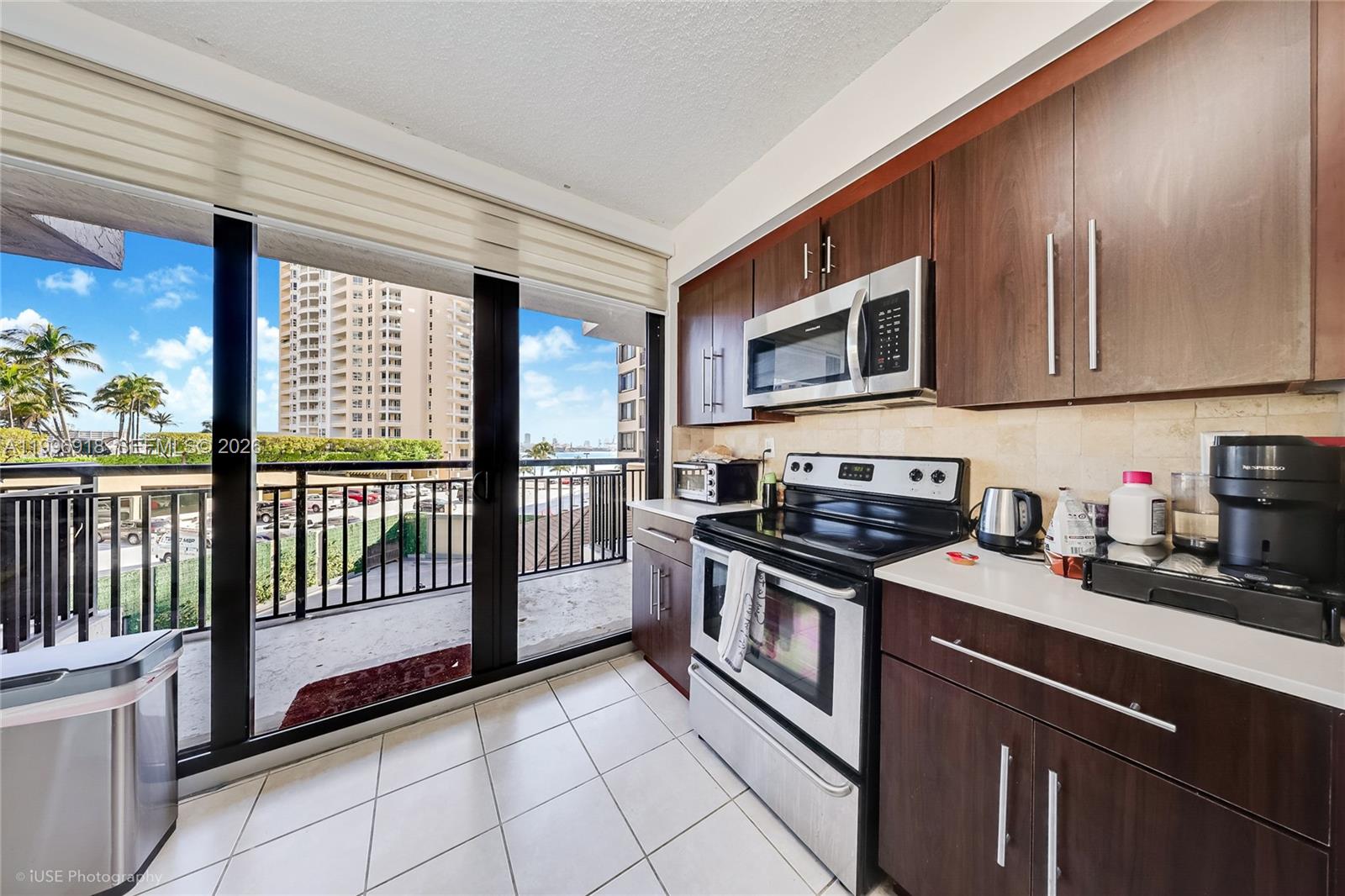 540 Brickell Key Drive, Unit 608 Miami, FL 33131 - Photo 12 of 15 a kitchen with stainless steel appliances granite countertop a stove sink and cabinets