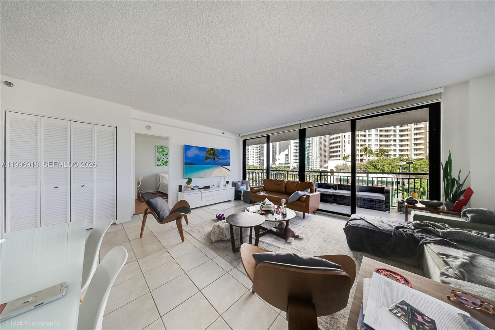540 Brickell Key Drive, Unit 608 Miami, FL 33131 - Photo 15 of 15 a living room with furniture and floor to ceiling window