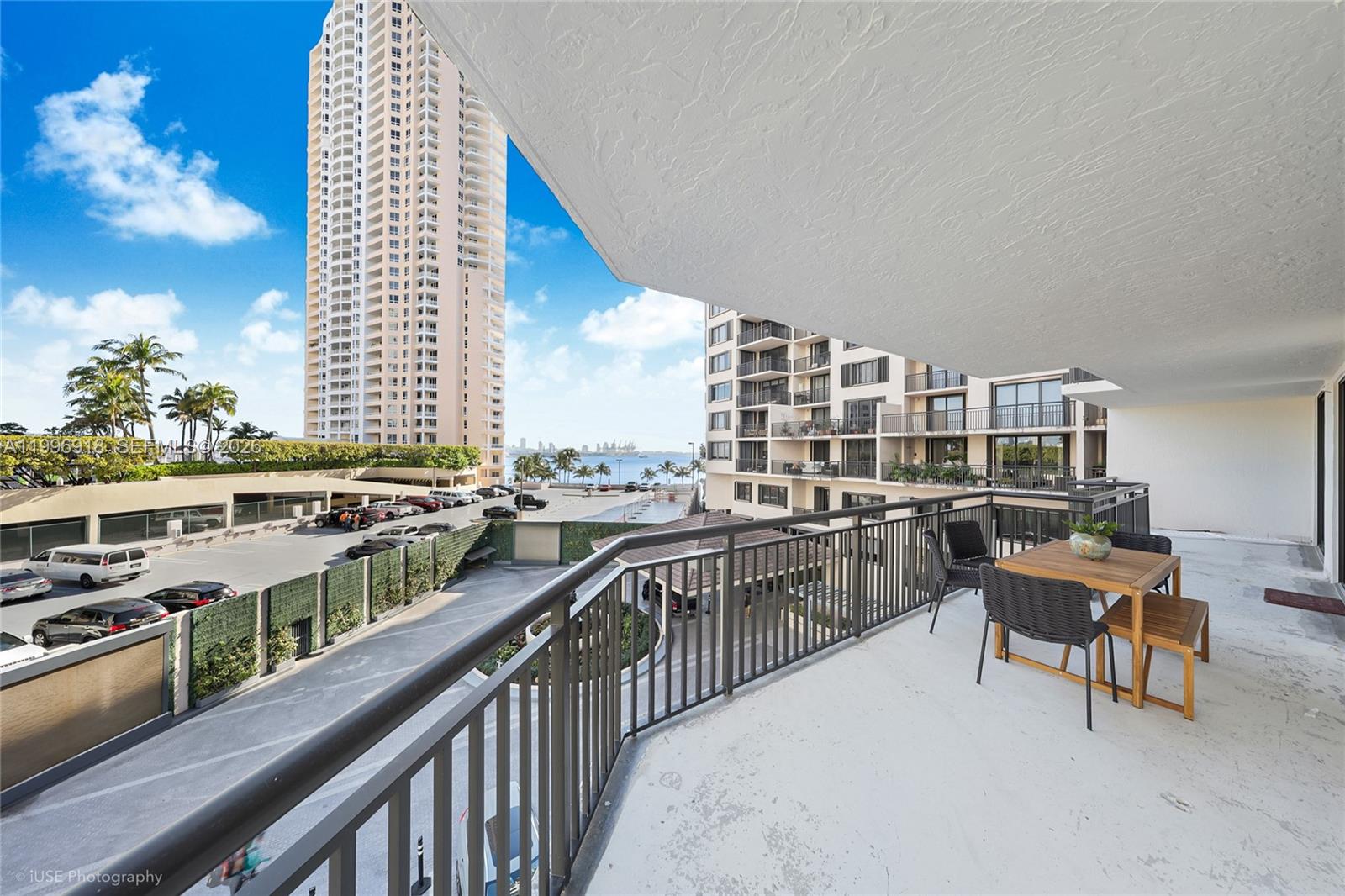 540 Brickell Key Drive, Unit 608 Miami, FL 33131 - Photo 2 of 15 a balcony with furniture and a city view