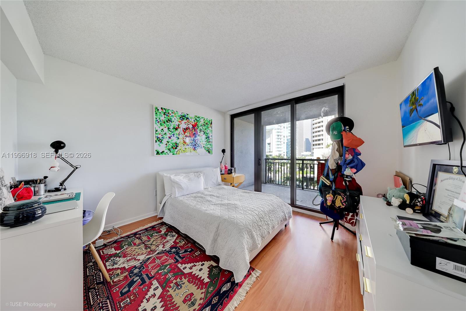540 Brickell Key Drive, Unit 608 Miami, FL 33131 - Photo 4 of 15 a bedroom with bed and a wooden floor