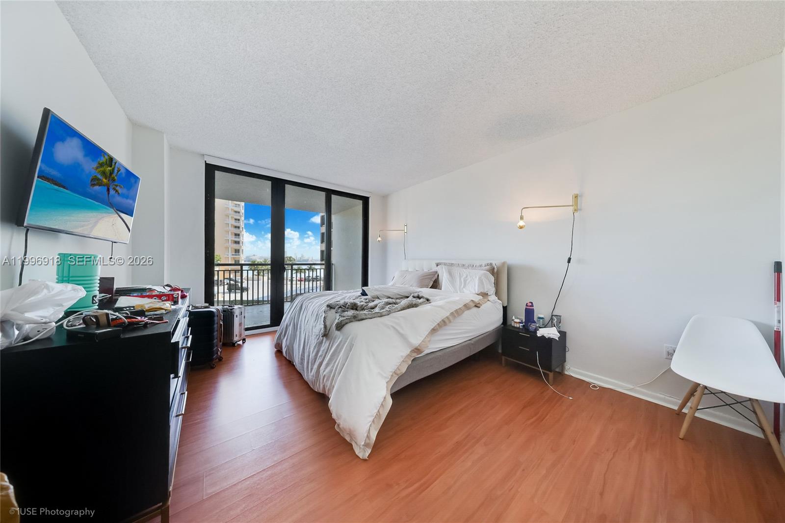 540 Brickell Key Drive, Unit 608 Miami, FL 33131 - Photo 6 of 15 a bed room with a bed and a chair