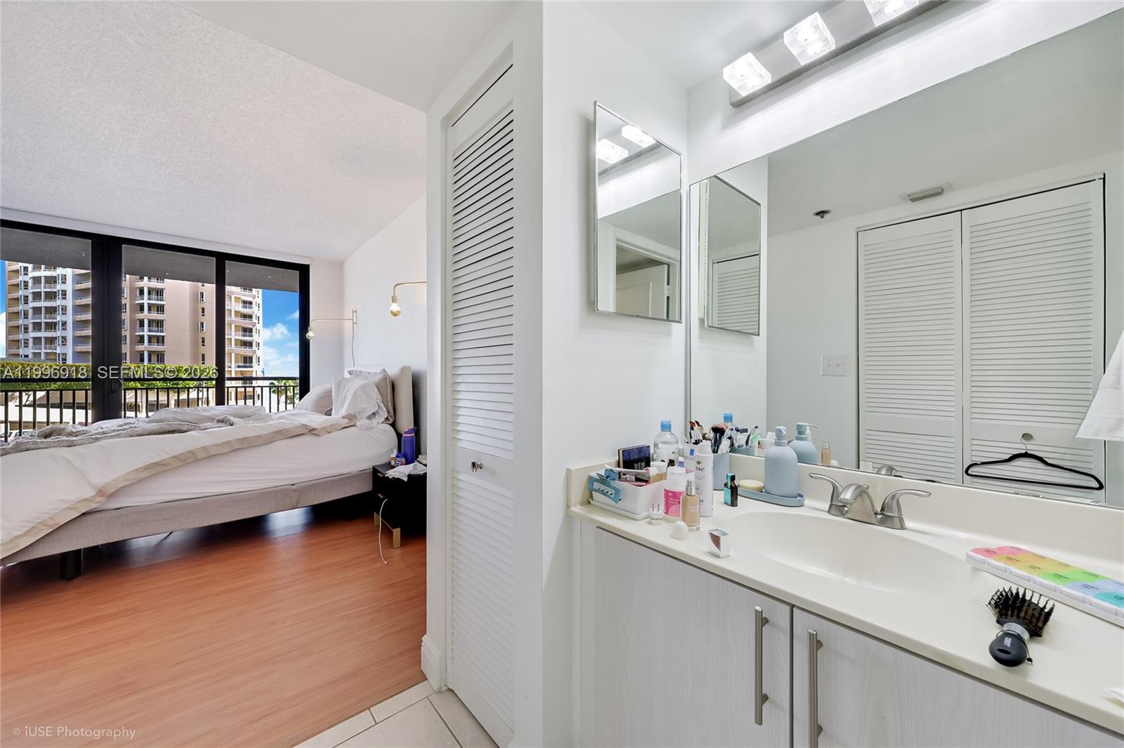 540 Brickell Key Drive, Unit 608 Miami, FL 33131 - Photo 9 of 15 a en suite bathroom with sink and a large mirror