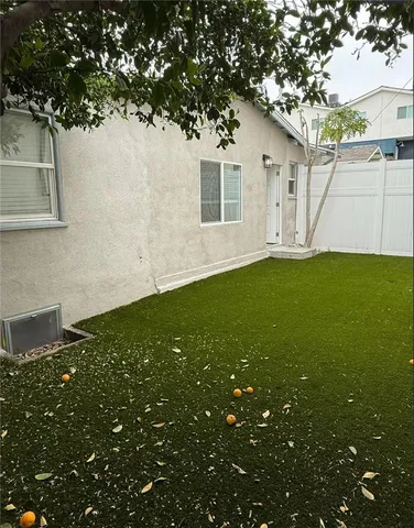 an empty room with wooden floor and entrance