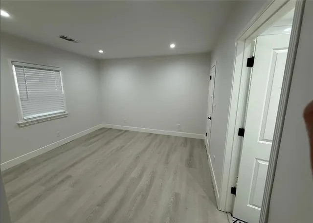 a white toilet sitting next to a shower