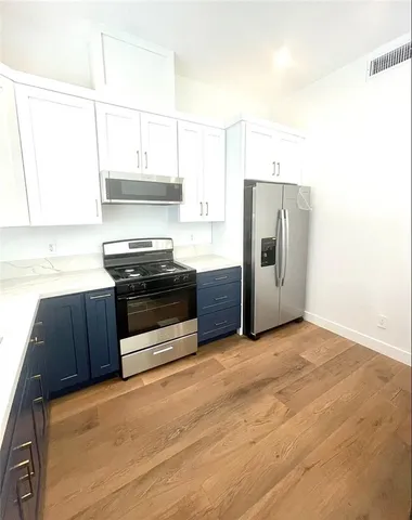 a view of an house with backyard space and balcony