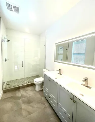 a view of a big room with wooden floor and a window