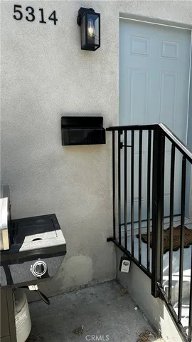 a view of staircase with wooden floor and chair