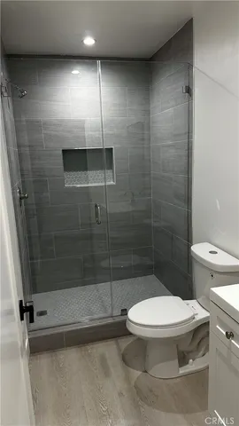 a kitchen with a refrigerator and a stove top oven