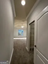 a spacious bathroom with a tub a sink and mirror
