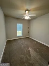 a large kitchen with stainless steel appliances granite countertop a stove top oven a sink dishwasher a refrigerator and cabinets with wooden floor